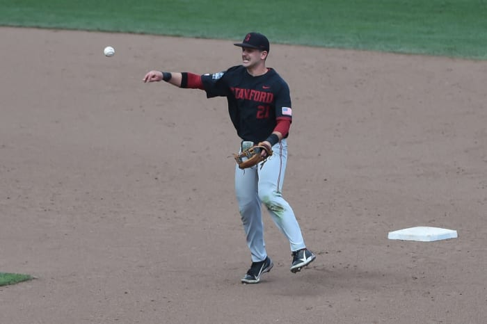 Jun 21, 2021; Omaha, Nebraska, USA; Stanford Cardinal infielder Tim Tawa (21) completes a double play against the Arizona Wildcats in the seventh inning at TD Ameritrade Park. Mandatory Credit: Steven Branscombe-USA TODAY Sports
